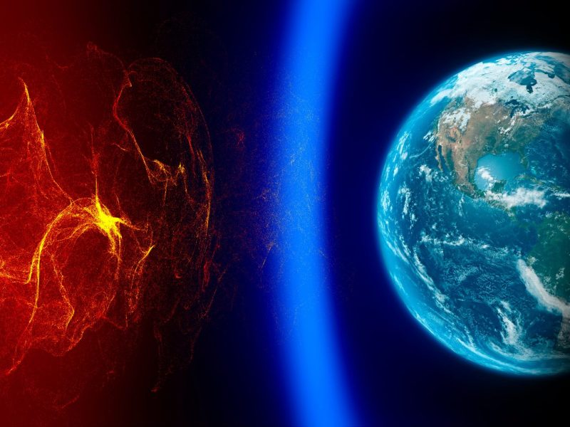 Illustration eines Sonnensturms der das Magnetfeld der Erde trifft.