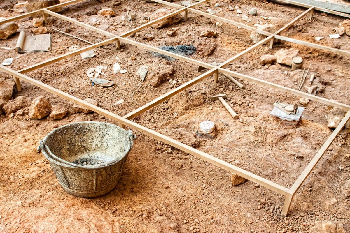 Werkzeuge liegen neben einem archäologischen Fund.