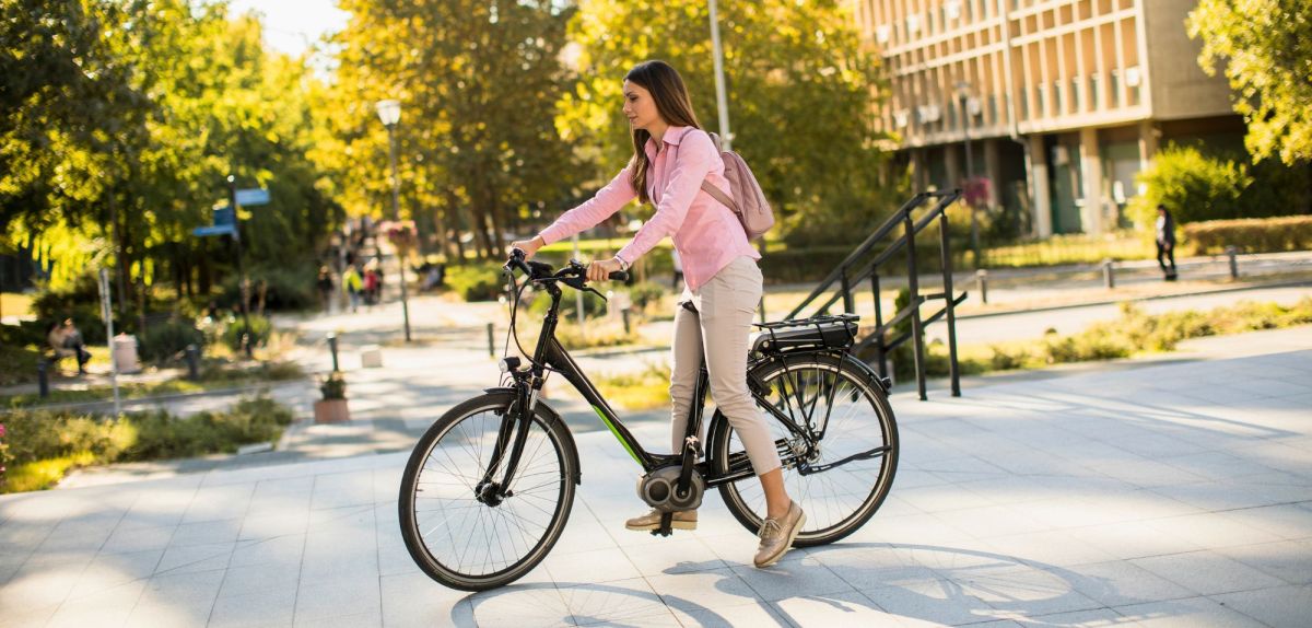 Frau fährt E-Bike in der Stadt