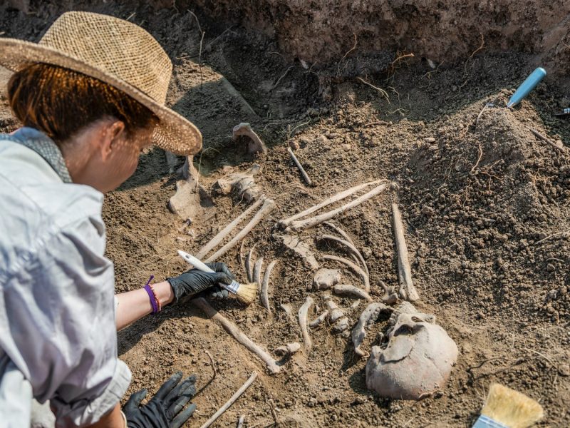 Frau arbeitet an einem archäologischen Fund.