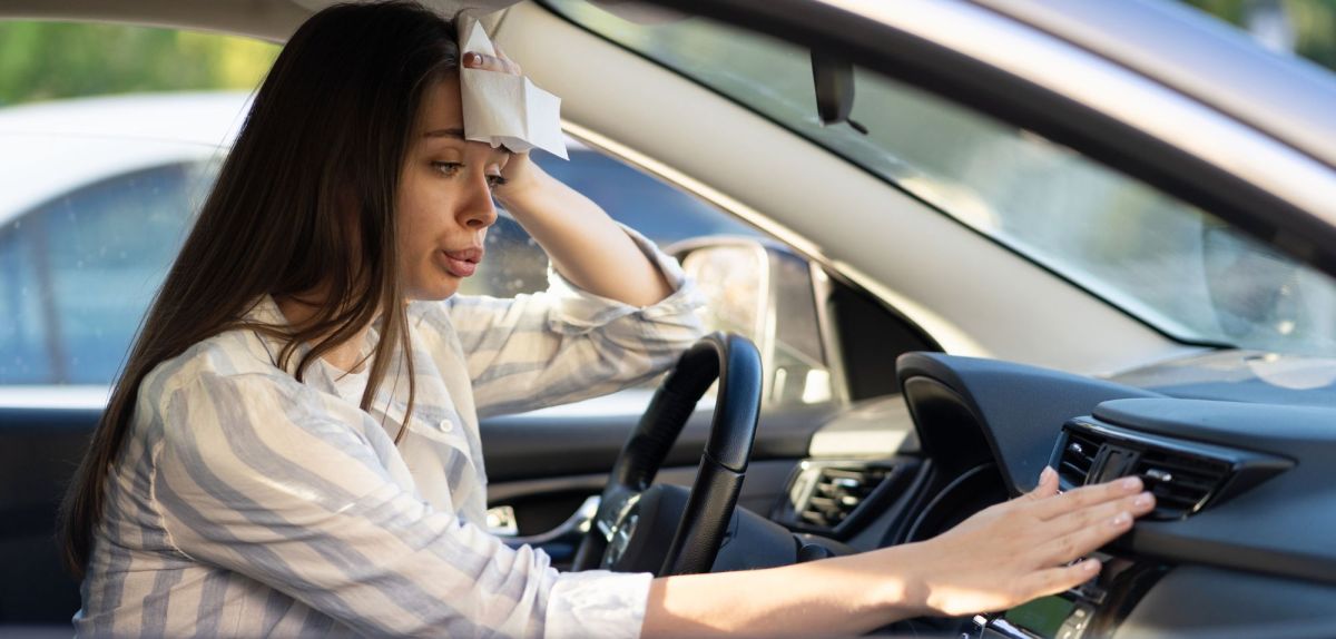 Frau schwitzt im Auto