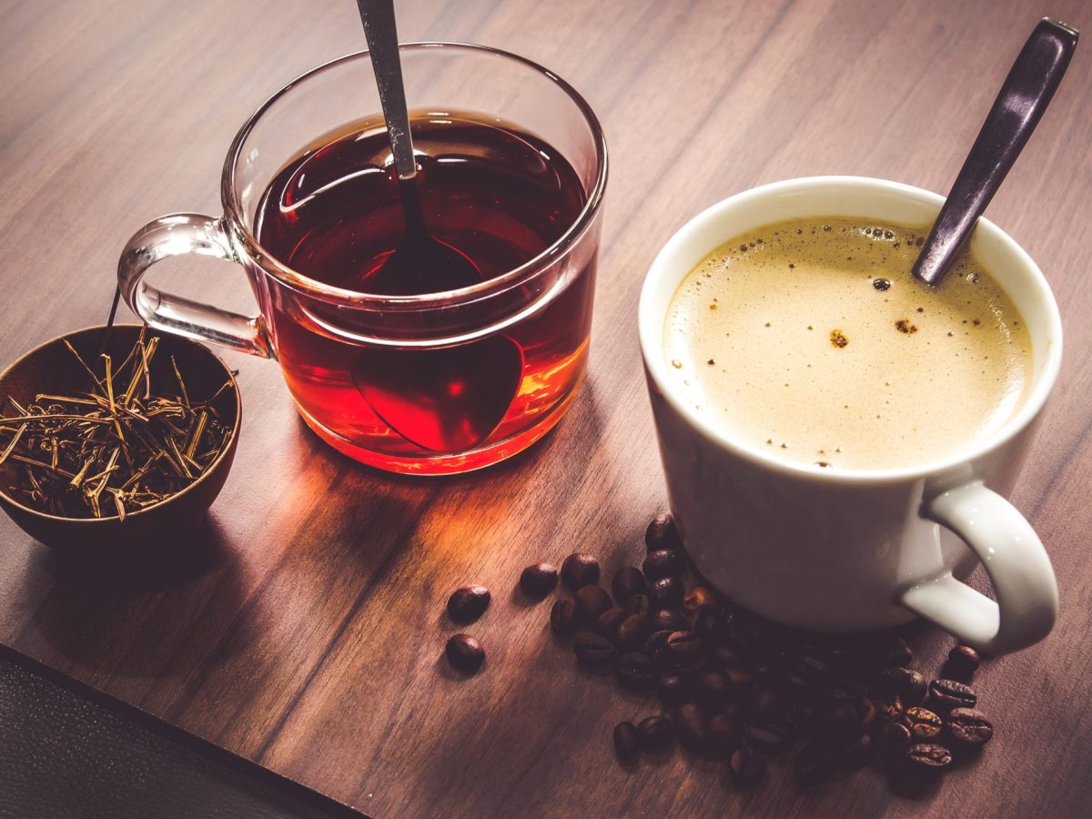 Tassen mit Kaffee und Tee auf einem Tisch