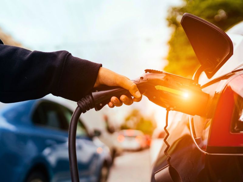 Person lädt ein Elektroauto